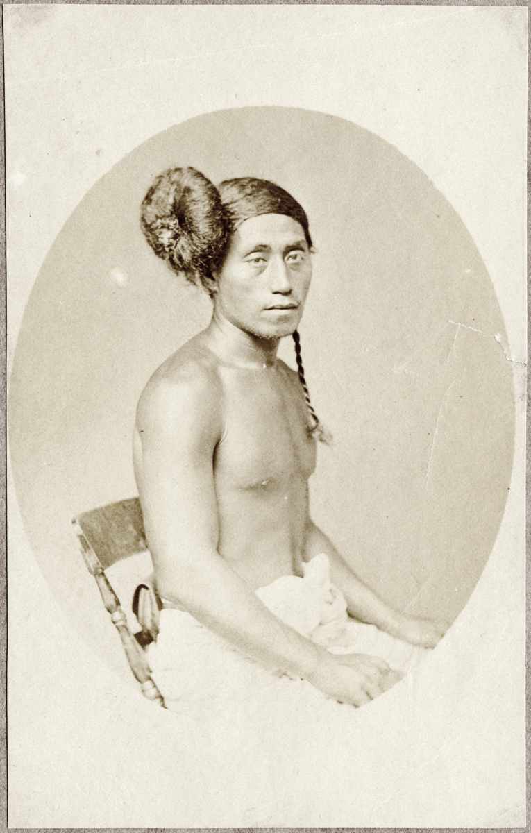 Black and white portrait photograph of a Samoan person with bound hair