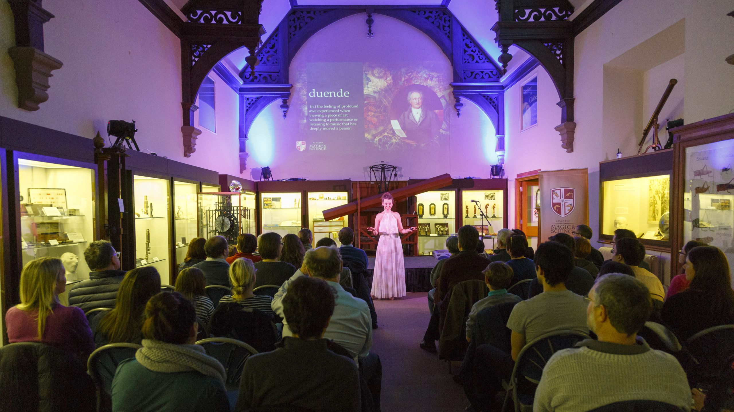 An audience in the Whipple Museum's Main Gallery, watching a magic show