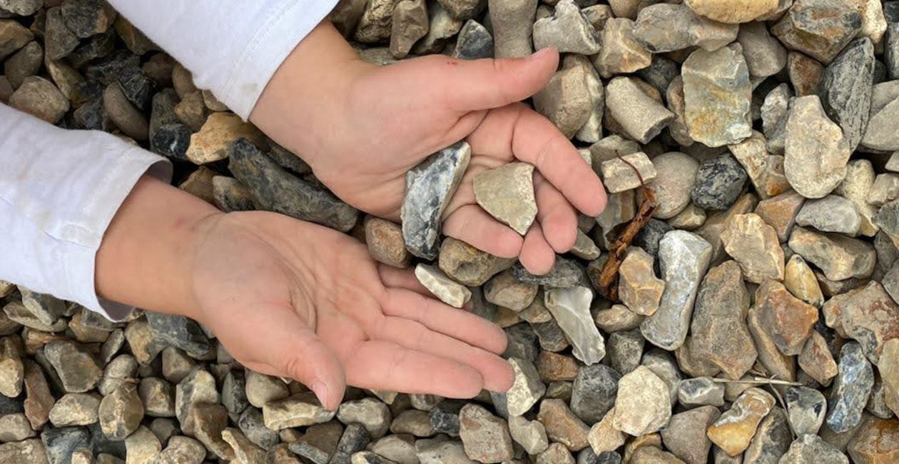 A child holding gravel