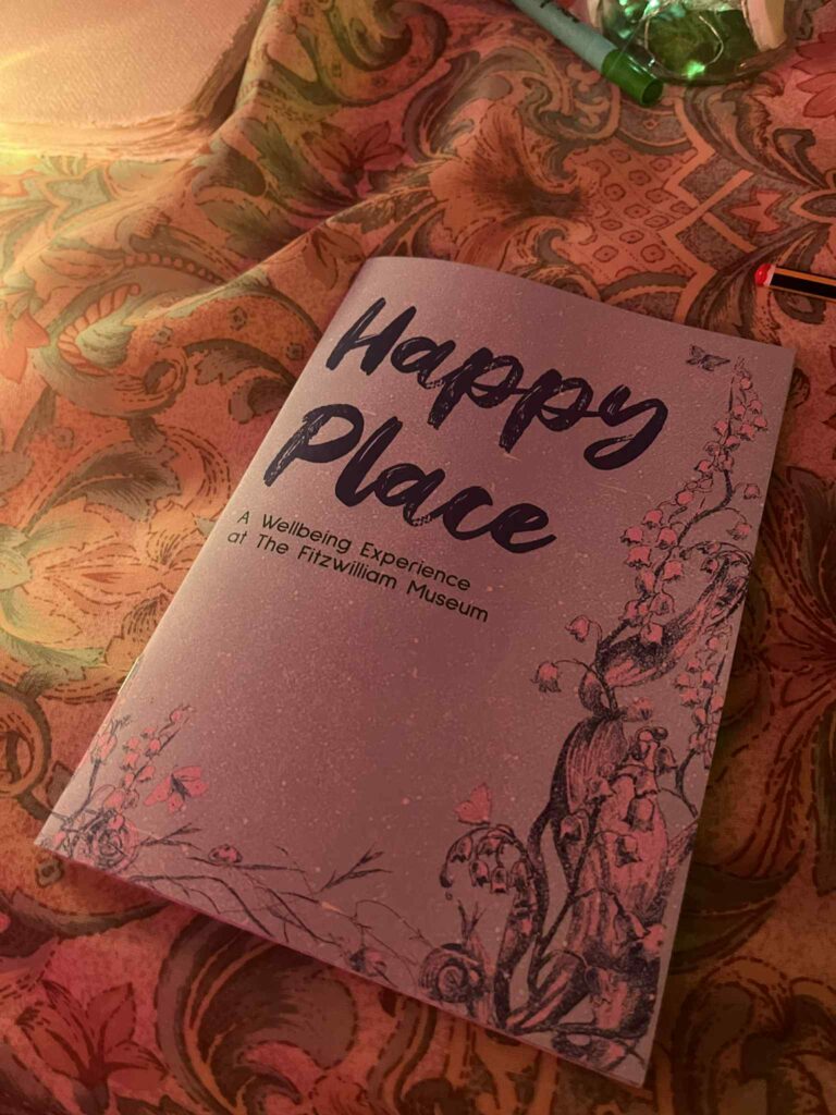 A Happy Place booklet resting on patterned fabric at the pop up.