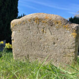 The recently rediscovered footstone marking the grave of Anna Maria Vassa, inscribed ‘A M V / 1797’ in St Andrew’s Churchyard, Chesterton.