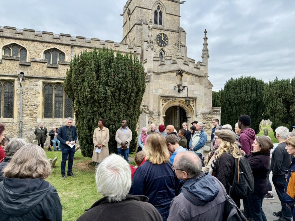 A group of people gathered around Anna Maria Vassa’s newly discovered grave during the commemoration event on Saturday 18 October at St Andrew’s Church, Chesterton.
