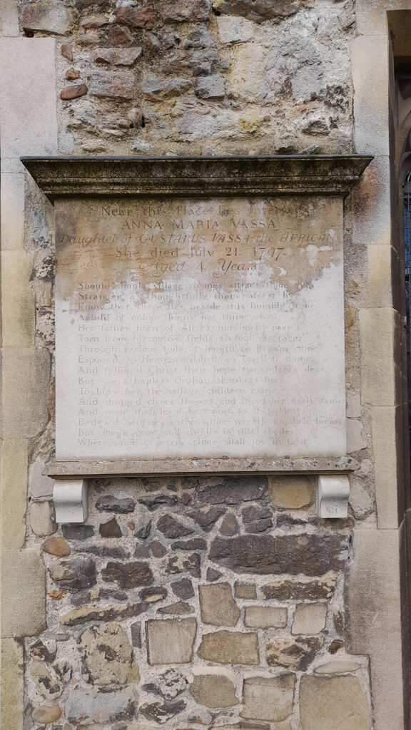 The stone exterior north wall of St Andrew Parish Church with an engraved Epitaph to Anna Maria Vassa (1793–1797).