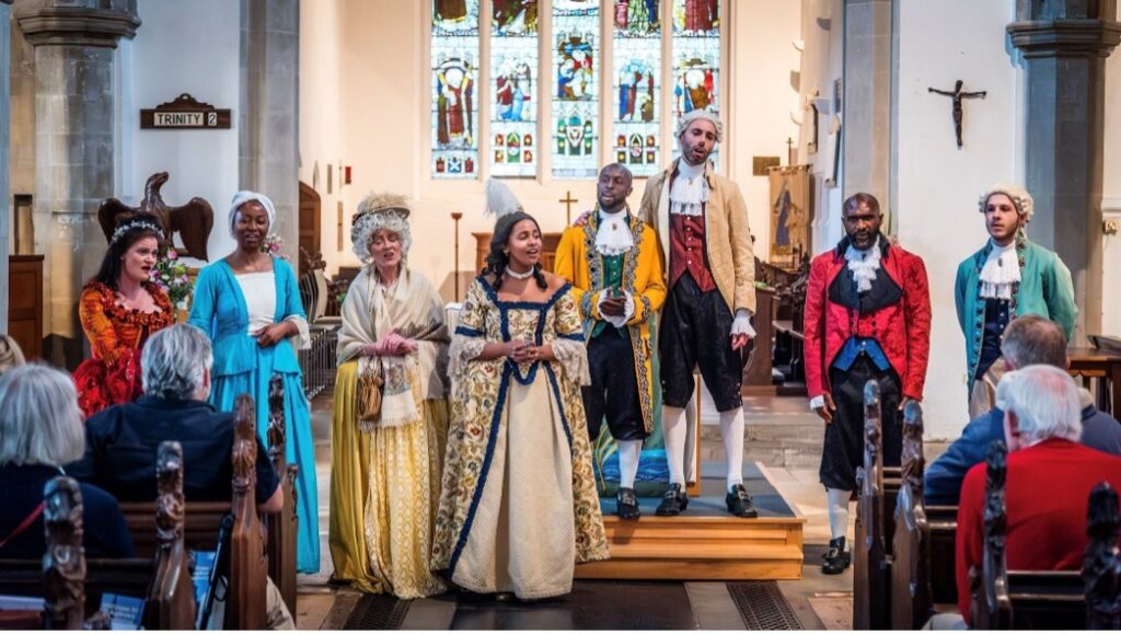 Eight performers in historical dress perform in St Andrew's.