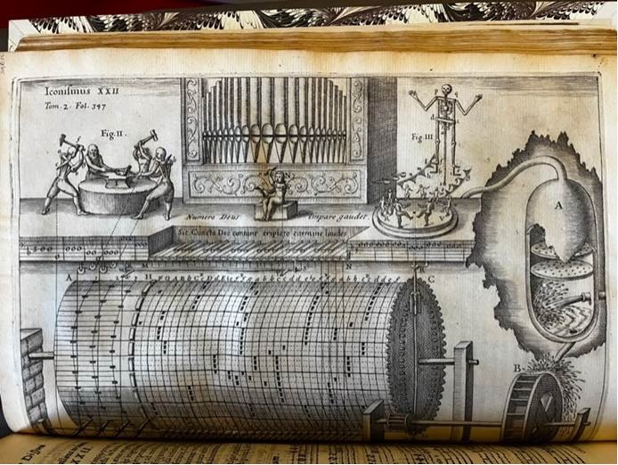 An open book showing a diagram of a proposed musical instrument.