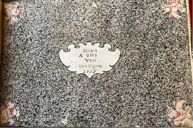 A handwritten inscription in a book with a white and black design.