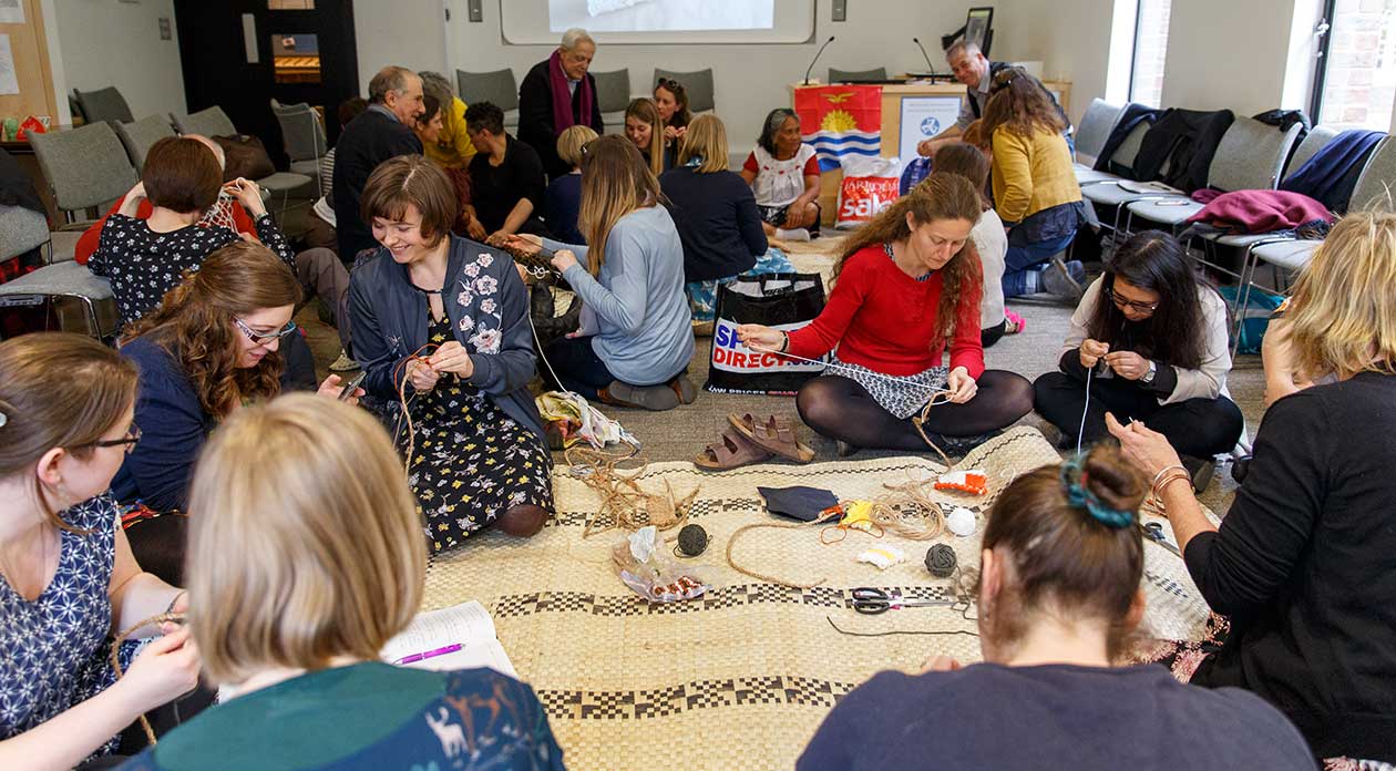 Photograph of participants in a weaving workshop  