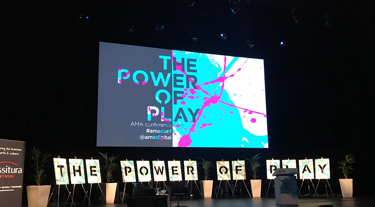 The stage at conference withPower of Play written on the screen