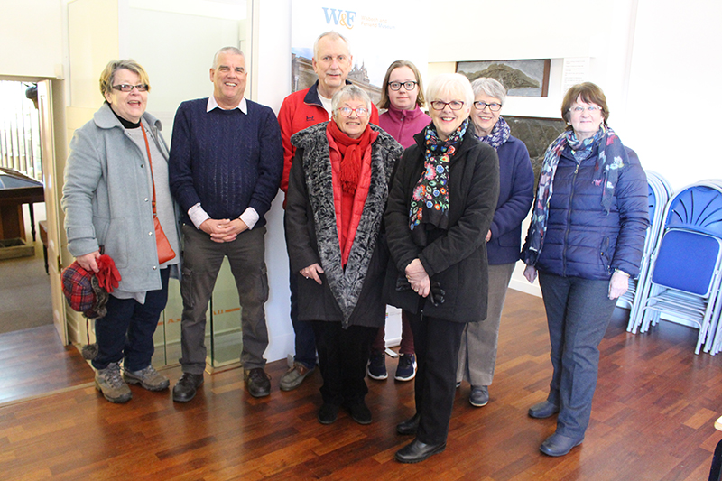 A group of eight smiling volunteers