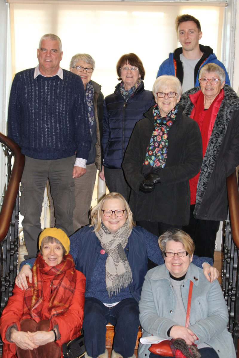 A happy group of staff and volunteers pose for a group photo