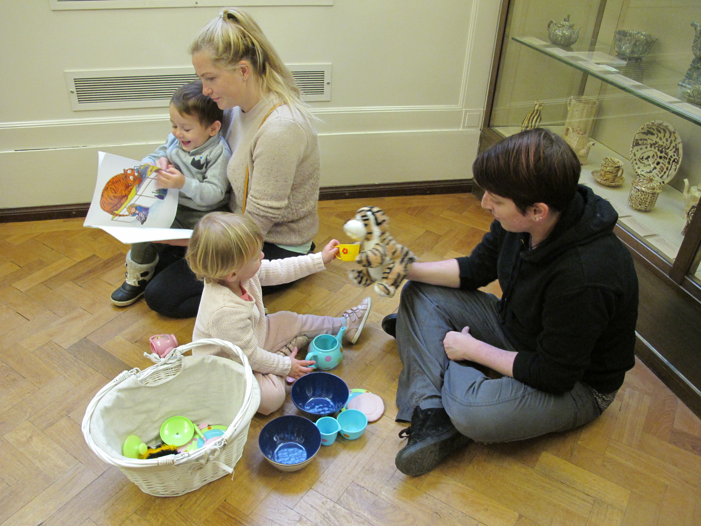 Parents and children taking part in activities in the Fitzwilliam Museum galleries