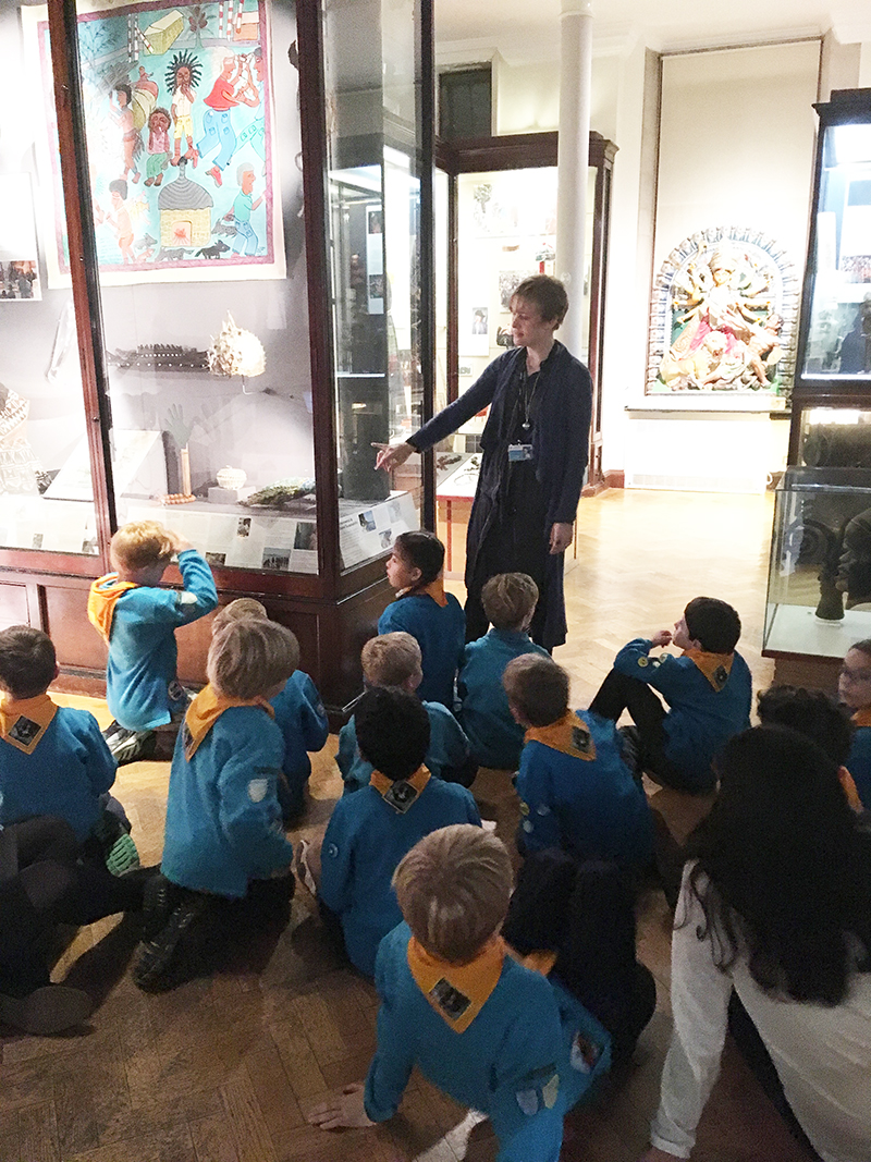 A class of primary school pupils listen to Jenny as she teaches in the gallery