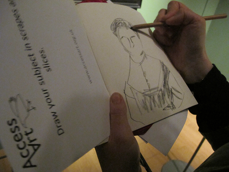 Close up on a paper workbook, where a participant is sketching