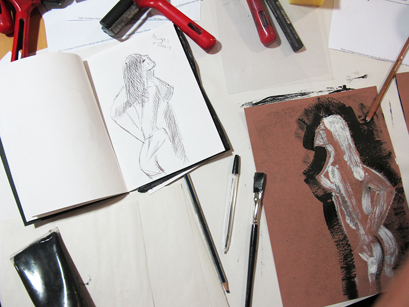 A print and sketch side by side. The print is of a female figure.