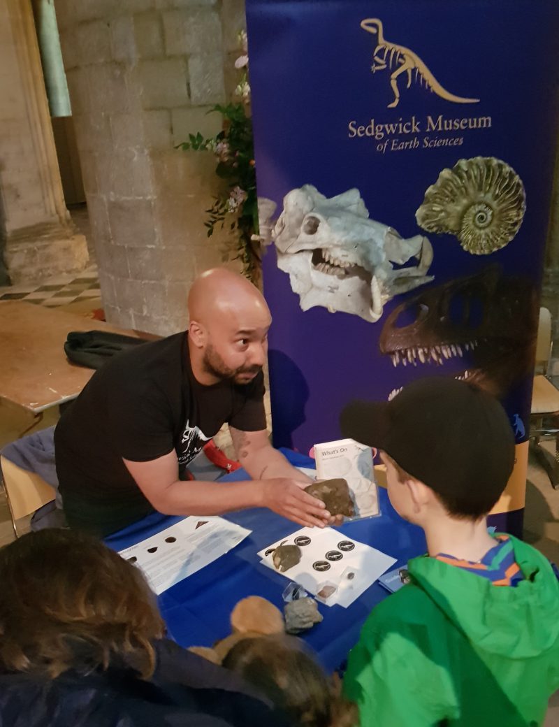 children looking at rock specimens at the Sedgwick Museum's stall