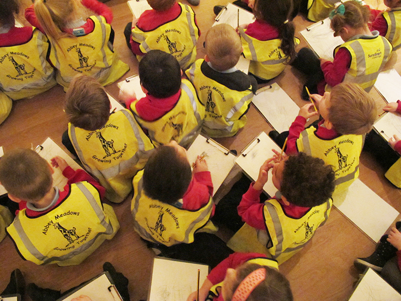 Class of children with clipboards