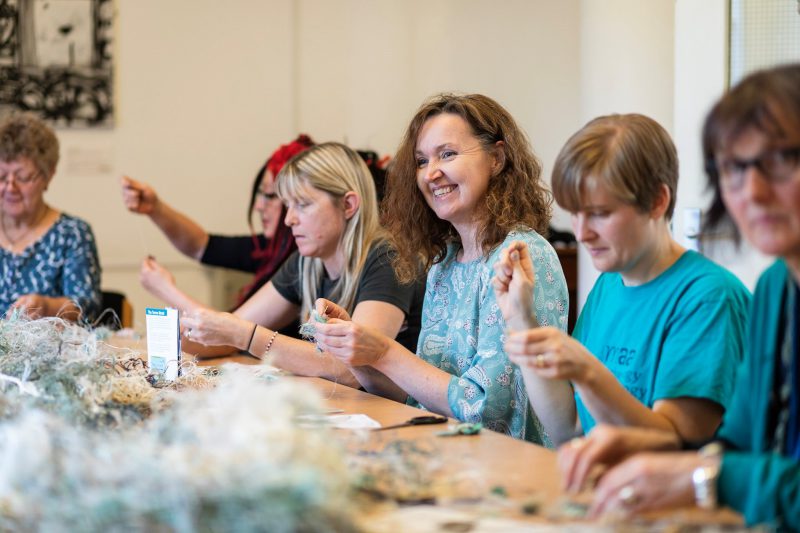 Participants of the Erub Arts' workshop make ghost net sculptures