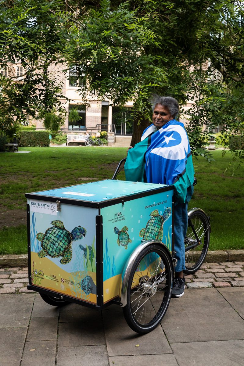 Florence Gutchen on the MAA cargo bike, with its blue box decorated with her turtle sculpture