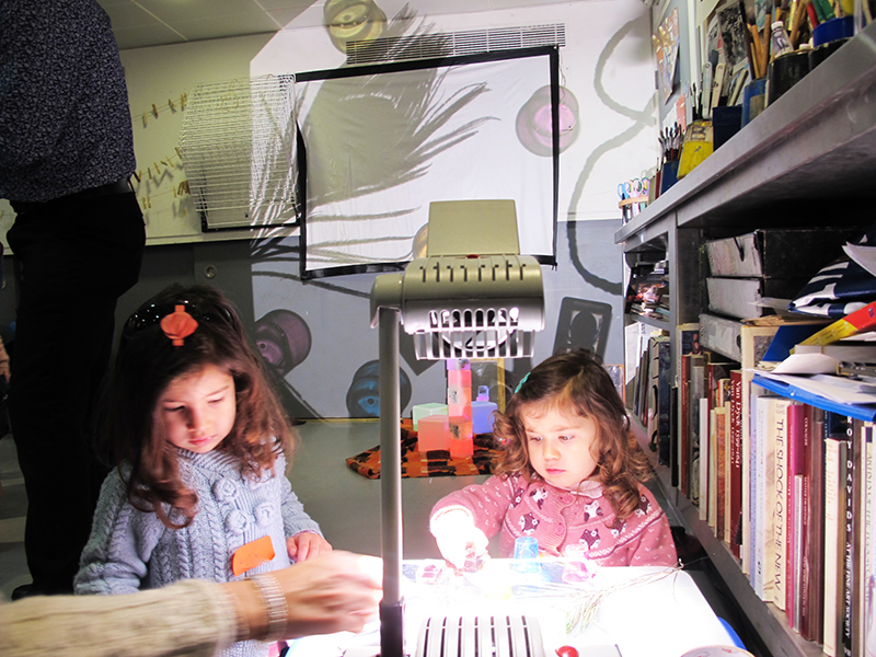 two little girls make shadow art