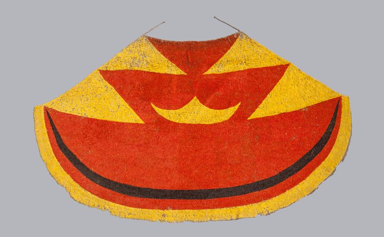 A bright red, yellow and black Hawaiian feather cloak