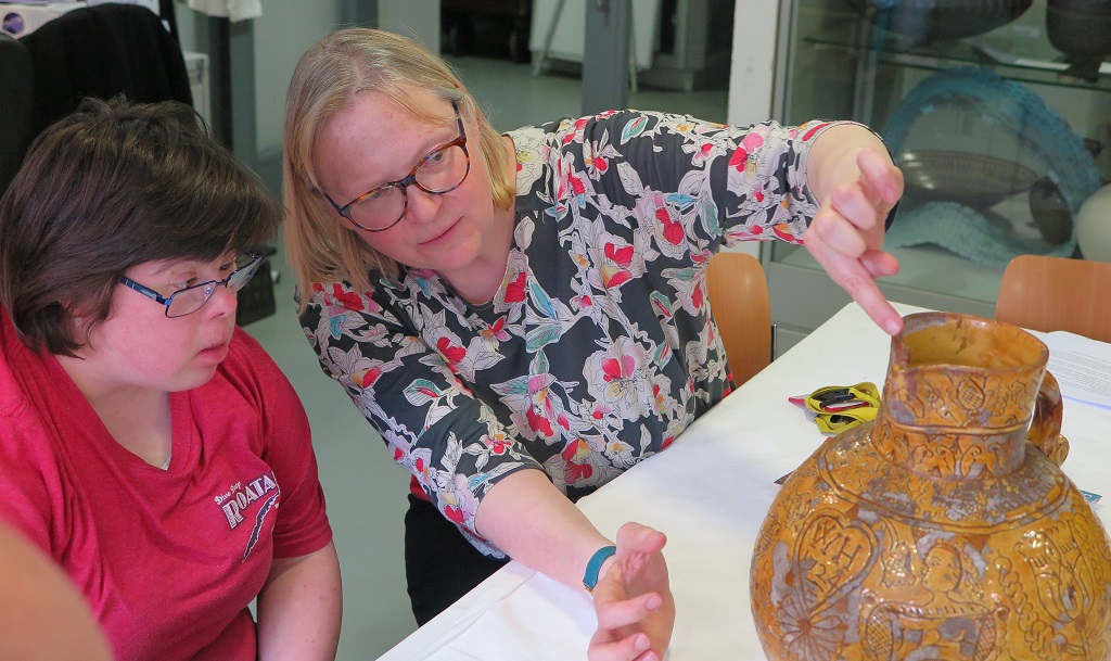 Emma and I discussing the flaking glaze and lively decorations on the Devon harvest jug