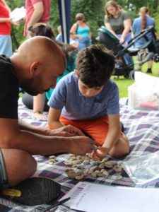 Rob looking closely at fossils with ChYpPSp participant