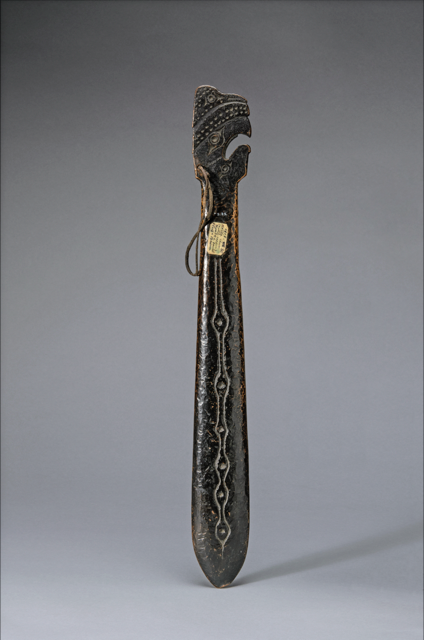 Bronze hand club with incised designs and bird-like head