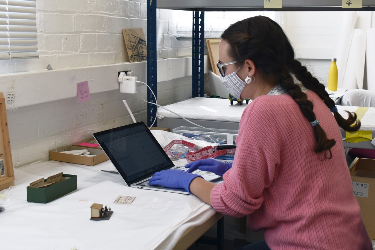 a member of the MAA stores move team documents an object on her laptop