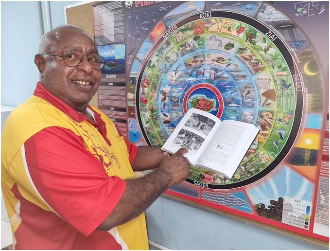 Falen D Passi, a direct descendant of Haddon’s friend and assistant Pasi, pointing to the photographs of his ancestors in Recording Kastom (see image above). Photo courtesy of Ian McNiven, Mer Island, Torres Strait, May 2021.