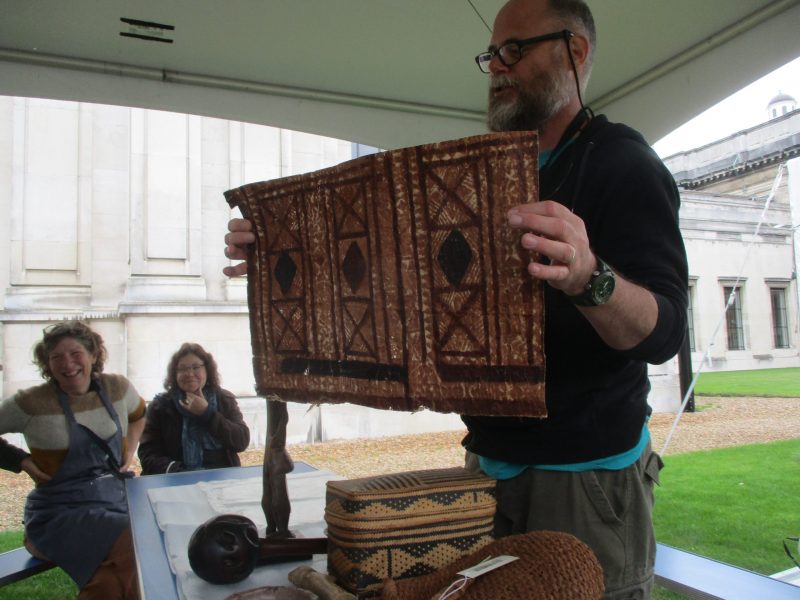 Person holding printed piece of bark cloth