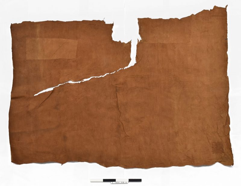 Barkcloth from Uganda with a large tear and showing areas where it has been patched