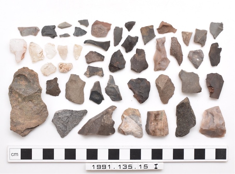 An assortment of stone fragments arranged by size.