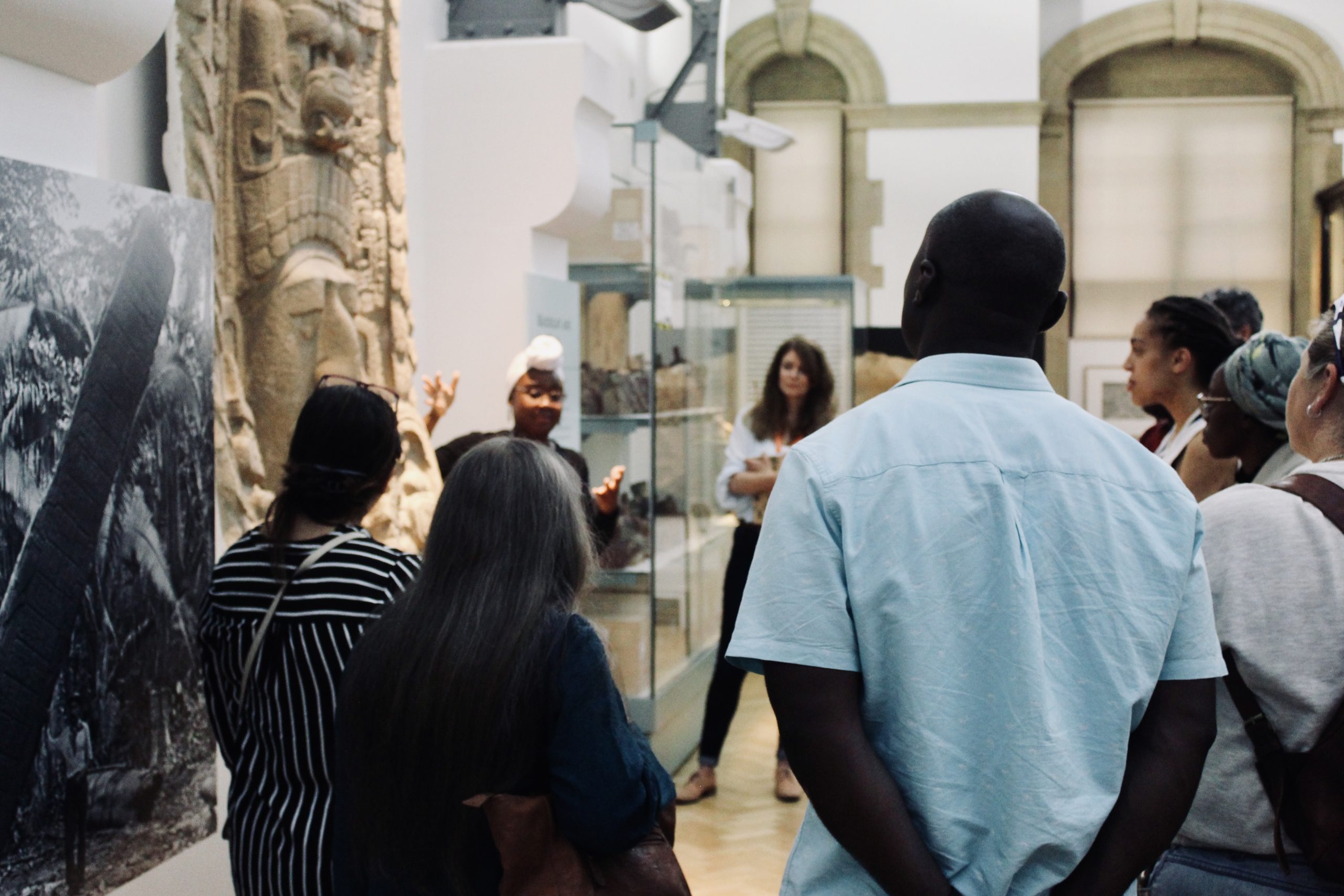 participants cluster around a relief in the Museum of Archaeology and Anthropology