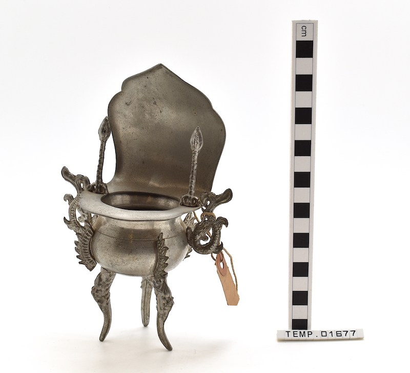 Small, silver coloured incense burner with ornate legs and hinged lid