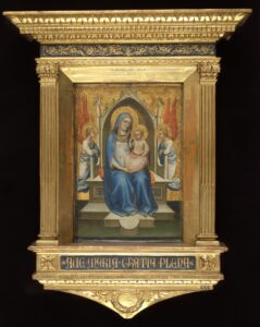 Painting of the Virgin Mary holding the infant Christ on her lap, attended by two angels. Mary's cloak is a deep ultramarine blue, and the painting and frame are heavily gilded in gold.