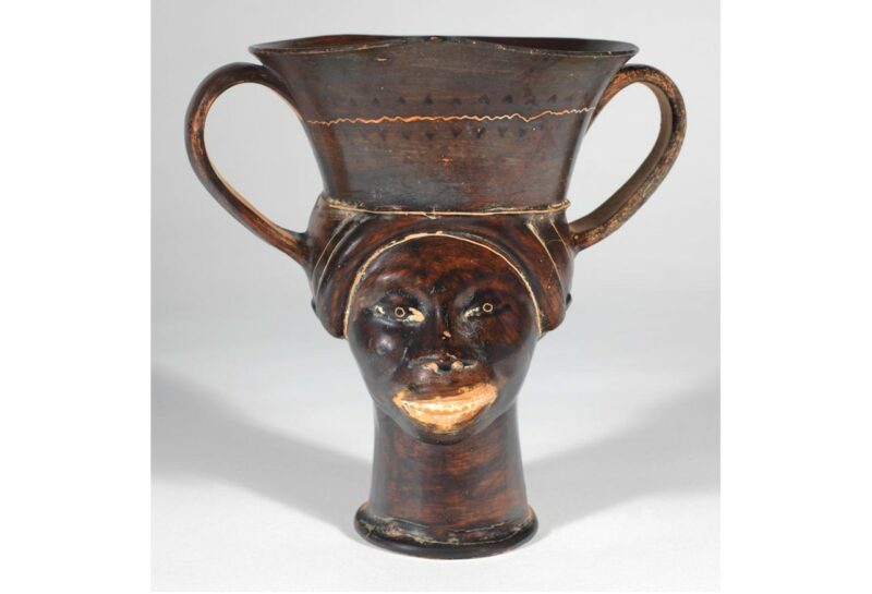 Greek vase showing face of a Black woman