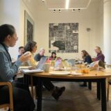 Group of researchers carrying out an online word-search in the Museum's archives