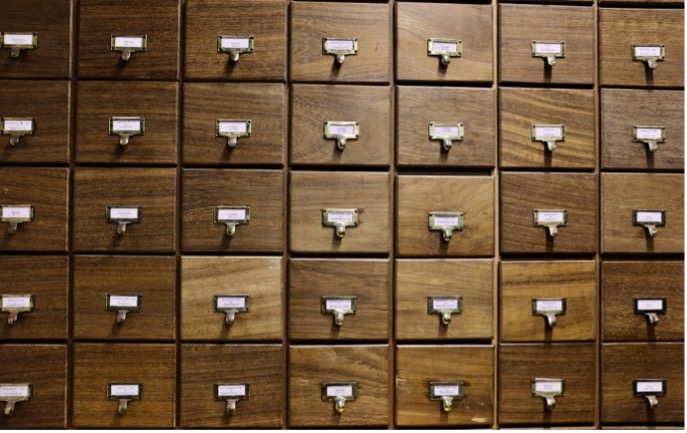 A set of labelled wooden drawers containing the bryophyte collection at Cambridge University Herbarium.