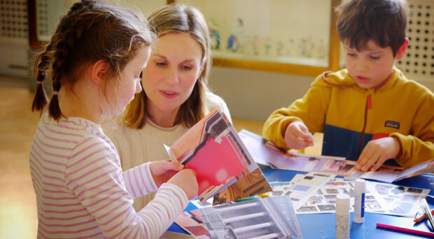 A woman with two children sit at a table at the Fitzwilliam Museum and create their own museum collage.