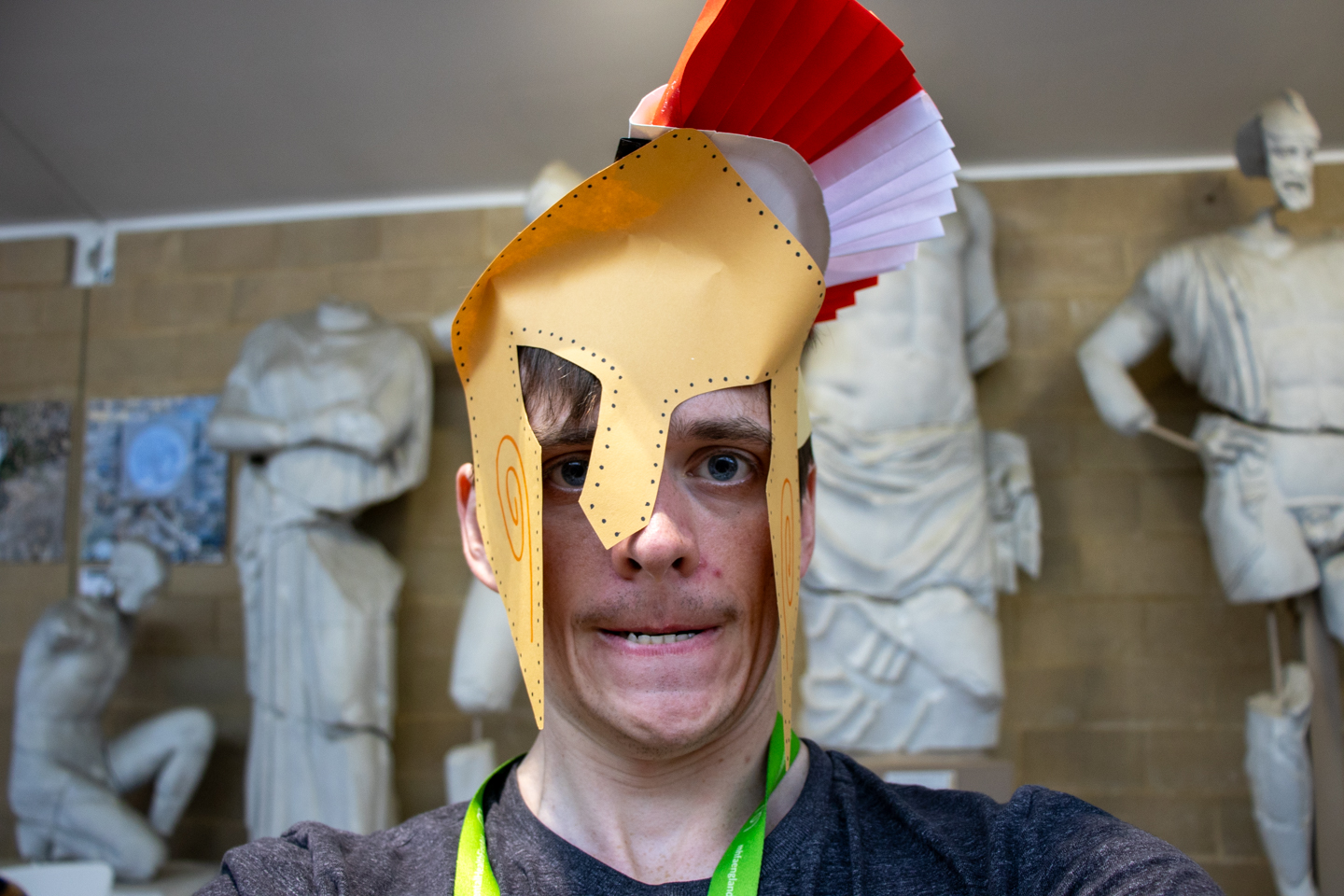 Person making a scary face while wearing a handmade paper helmet.