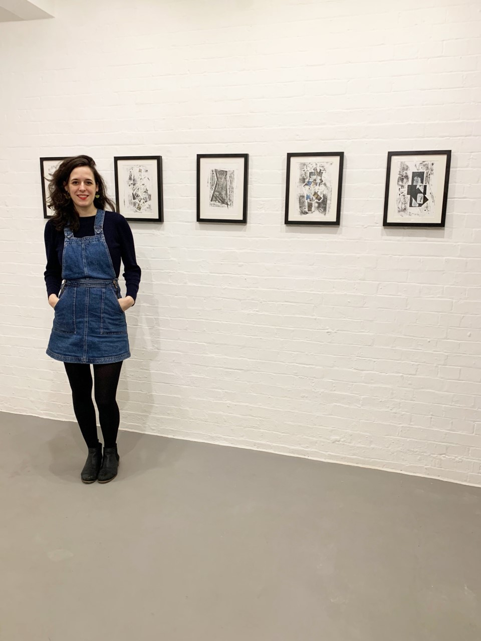 artist susie olczak standing in front of her art