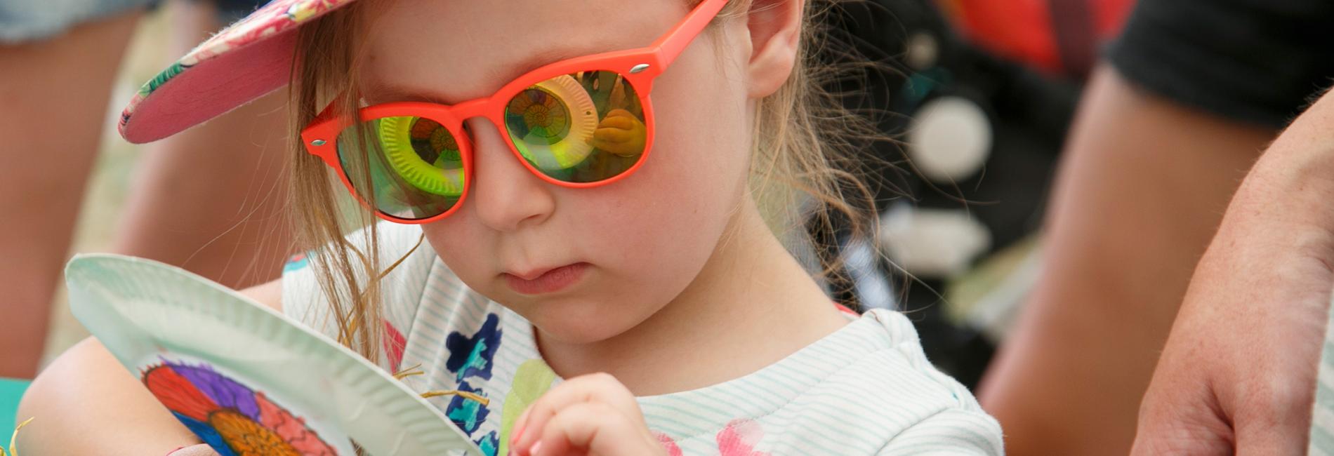 girl with ammonite pattern reflecting in her sunglasses