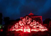 The greenhouse at night with red lights during the festival of lights event