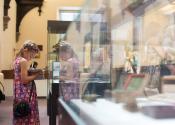 A child exploring the exhibits during summer at the museums