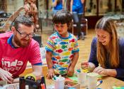 child and visitor take part in craft activities
