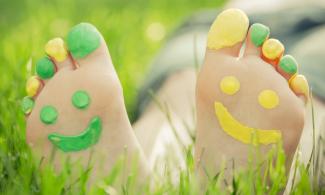 Feet with smiley face painted on them
