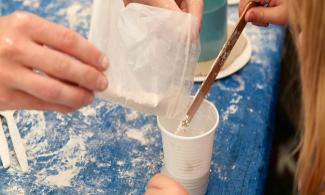 pouring plaster mix in cup