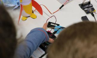 Child doing electronics activity