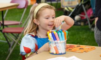 Girl decorating paper vase
