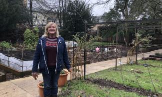 Staff member by the School's Garden at Cambridge Botanic Garden